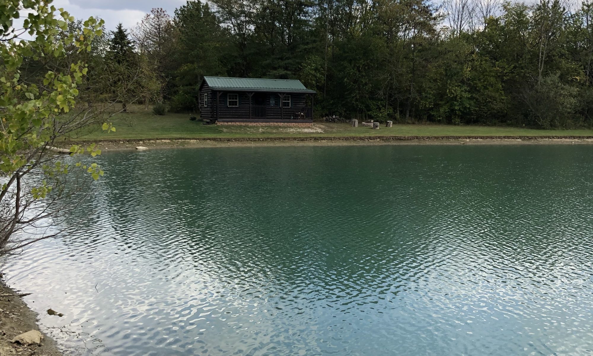Photo of a lake and a cabin at Innkeeper Ministries, Lewisburg, Ohio